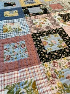 an old quilt is laying on the floor