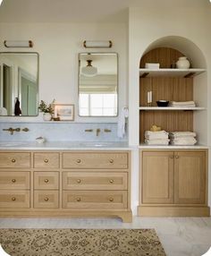 a bathroom with double sinks and wooden cabinets