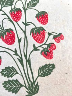 a drawing of strawberries on a piece of white paper with green leaves and red dots