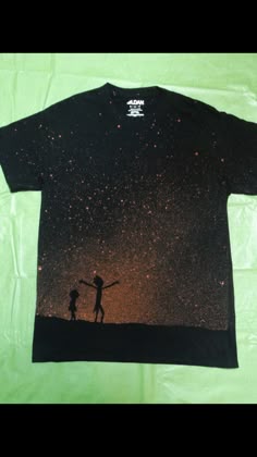 a t - shirt with the silhouette of two people holding hands in front of stars