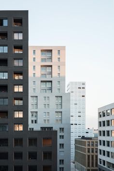 several tall buildings with windows and balconies