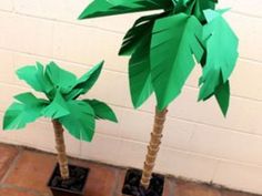 two paper palm trees sitting on top of each other