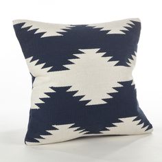 a blue and white pillow on a white background