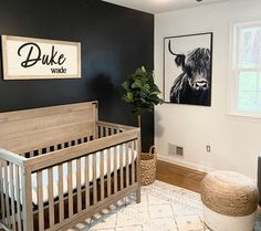 a baby's room with a wooden crib and black walls