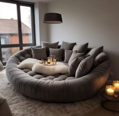 a living room filled with furniture and candles