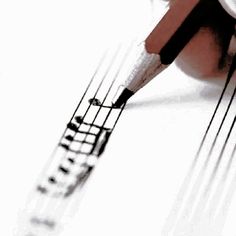 a pencil and some music notes on a white sheet with watermarked lines in the middle