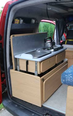 the back end of a van with two stoves in it's cargo area