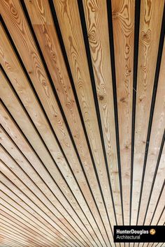 the inside of a building with wooden slats on it's walls and ceiling