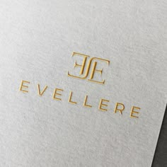 the logo for evellere is shown in gold on a white paper with black lettering