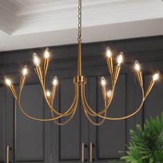 a chandelier with lights hanging from it's sides in a kitchen area