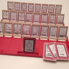 a set of cards with matching numbers and shapes in them on a pink tray next to some magnets