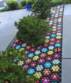 a colorful walkway made out of balls and plants