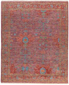 an orange and pink rug with blue, green, red and yellow flowers on it