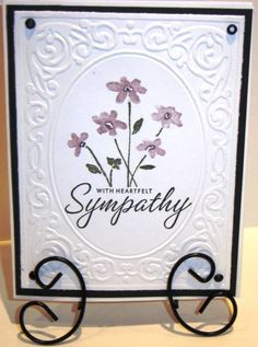 a card with some flowers on it and the words sympathy written in cursive writing