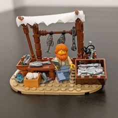 a lego pirate ship with an orange beard on it's head and other toys