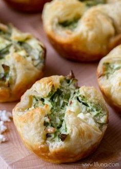 several small muffins with spinach and cheese in them