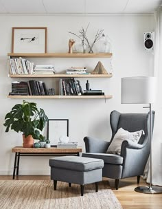 an image of a living room with furniture and bookshelves on the wall above