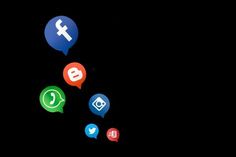 several different colored speech bubbles floating on top of each other in the dark with social icons above them