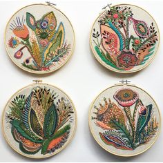 four embroidery hoops with different designs on them