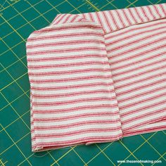 two pieces of fabric sitting on top of a cutting board