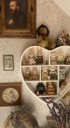 a heart shaped shelf filled with lots of figurines and knick - knacks