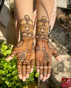 two hands with henna designs on them