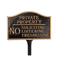 a black and gold sign that says private property soliciting no loitering trespassing