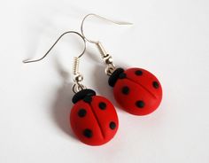 pair of ladybug earrings on white background