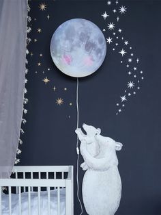 a baby's room with stars and a moon painted on the wall