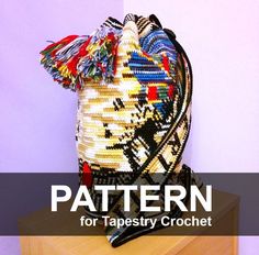 a bag made out of different types of beads on top of a wooden stand with the words pattern for tapestry crochet