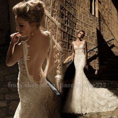 a woman in a wedding dress standing next to a stone wall