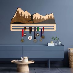 a blue wall with medals hanging from it's sides and a table in the foreground