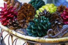 pine cones and other plants are in a basket on the table, ready to be used as decorations