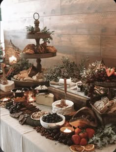 a table topped with lots of different types of foods and desserts on top of it