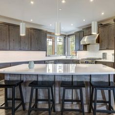 a large kitchen with an island in the middle