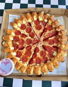 two pizzas sitting on top of cardboard boxes covered in pepperoni and other toppings