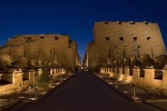 the entrance to an ancient city at night