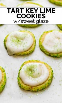 some cookies with white icing and green sprinkles