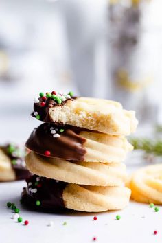 a stack of cookies with chocolate frosting and sprinkles on the top