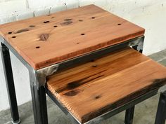 two wooden stools sitting next to each other