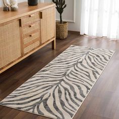 Wild style. This glam area rug showcases striking detail and hues of taupe and light gray that set a neutral foundation in your space. Featuring a nature-inspired pattern, this rug shows off fluid, diagonal stripes arranged in an eclectic design that reminds us of zebra stripes. Power-loomed from polypropylene, it shows off a low 0.3'' pile height that balances underfoot cushioning with a low-profile feel that's ideal for high-traffic rooms. Plus, it's easy to vacuum when it needs a refresh. We Light Grey Area Rug, Interior Rugs, Eclectic Design, Kitchen Mirror, Stick On Tiles, Indoor Rugs, Vinyl Flooring, Black Charcoal, Grey Area Rug