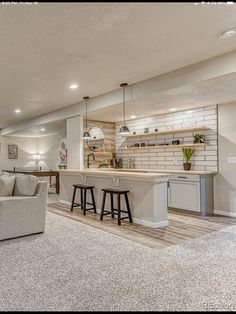 a living room filled with furniture next to a kitchen and dining area in a home