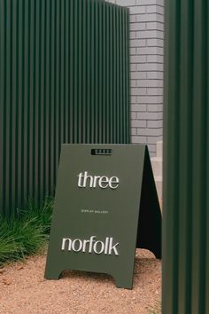 there is a sign in front of a building that says three norfolk on the side