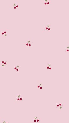 a pink background with cherries on it