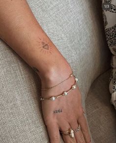 a woman's hand with a small tattoo on it