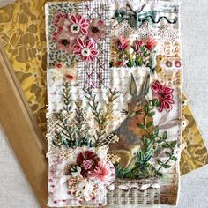 two pieces of fabric with flowers on them and a book laying next to each other