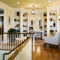 a living room filled with furniture and lots of bookshelves on top of it