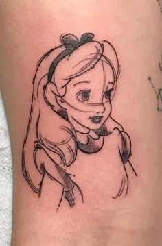 a woman's leg with a cartoon character tattoo on the side of her thigh