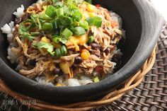 a black bowl filled with food on top of a table