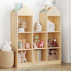 a wooden shelf filled with lots of books and stuffed animals next to a white wall